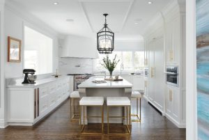 modern kitchen with ceiling crown moulding and golden trim on kitchen cabinets