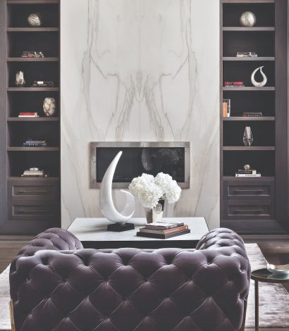 luxury living room with marble wall decor and build in fireplace