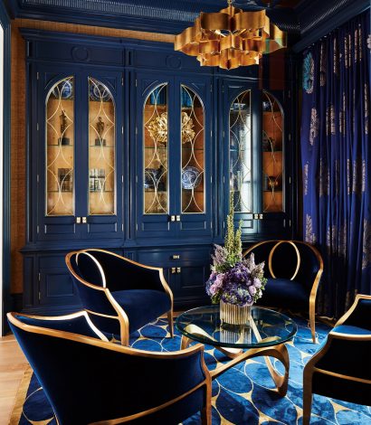 beautiful blue dining room with storage cabinet and blue carpet