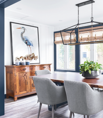 amazing dining room with blue frame painting and wooden floor