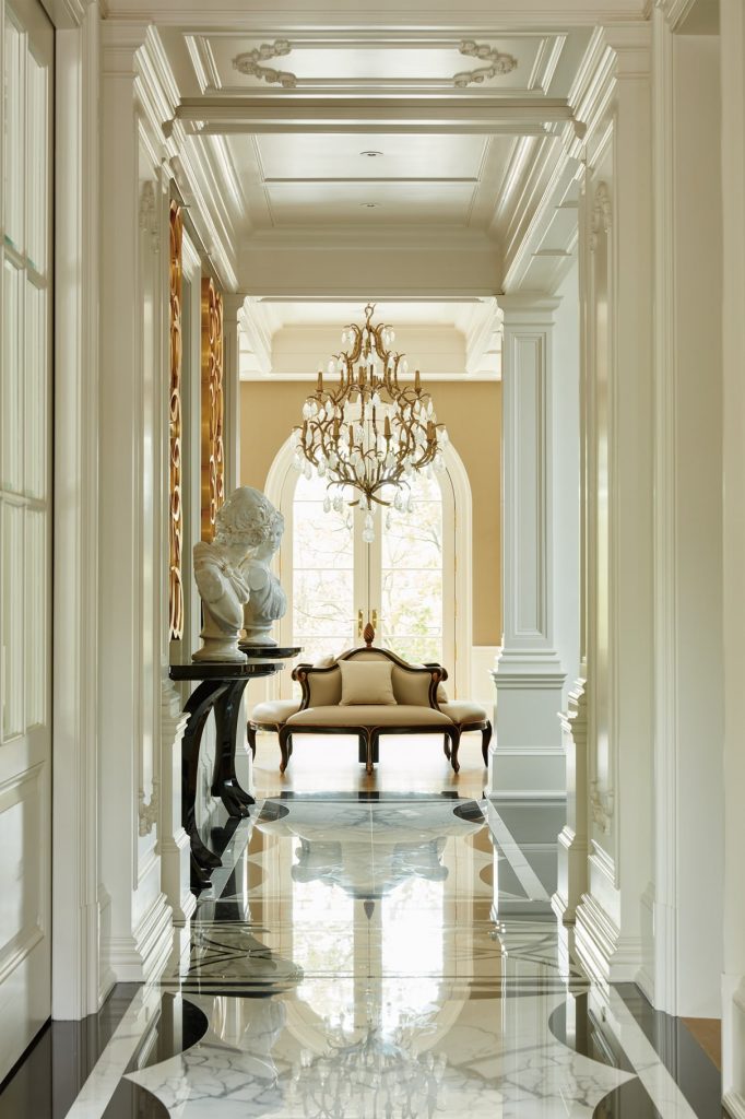 luxury hallway with crown moulding and base board trim