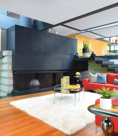 unique homes- custom living room with orange sofa and stone stairs