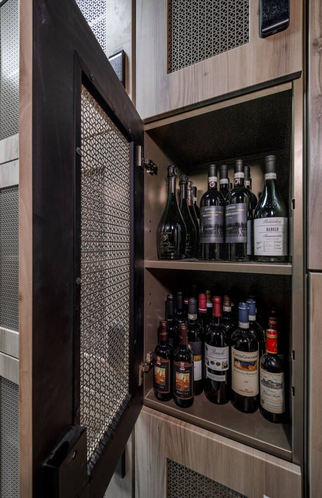 wooden cabin semi open with bottles of wine inside