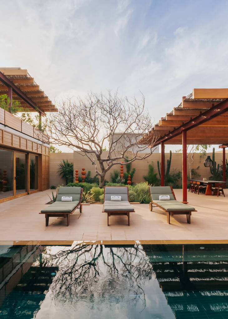 outside pool view with sun chairs