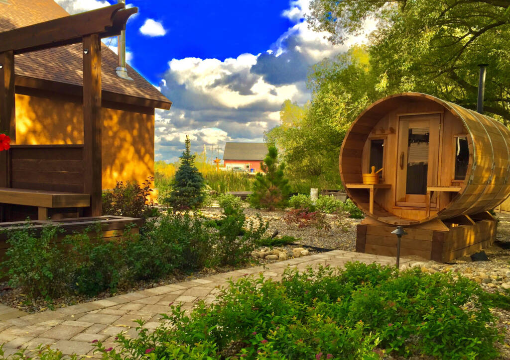 wooden round outside sauna in a backyard