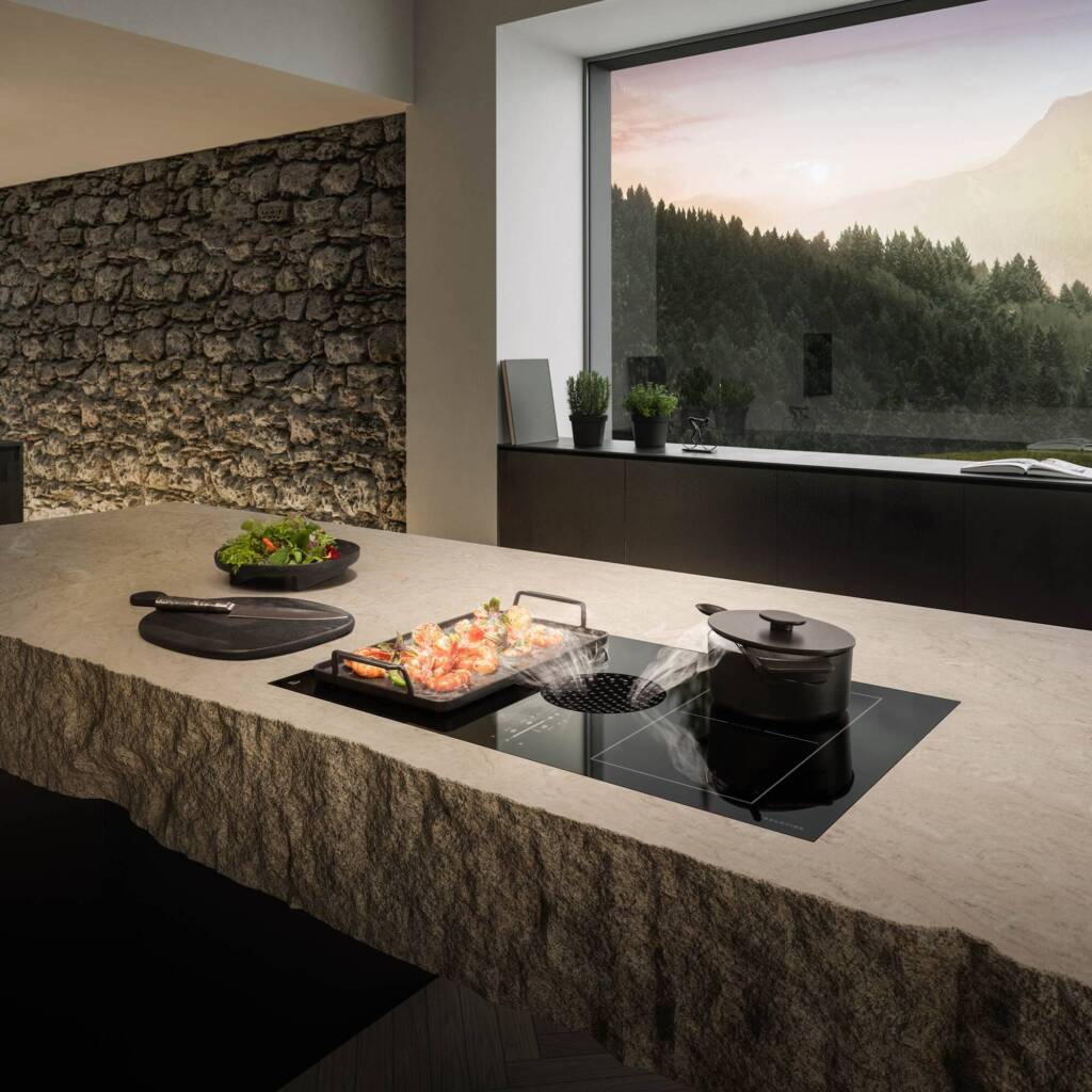 kitchen counter with cook top and window in the back