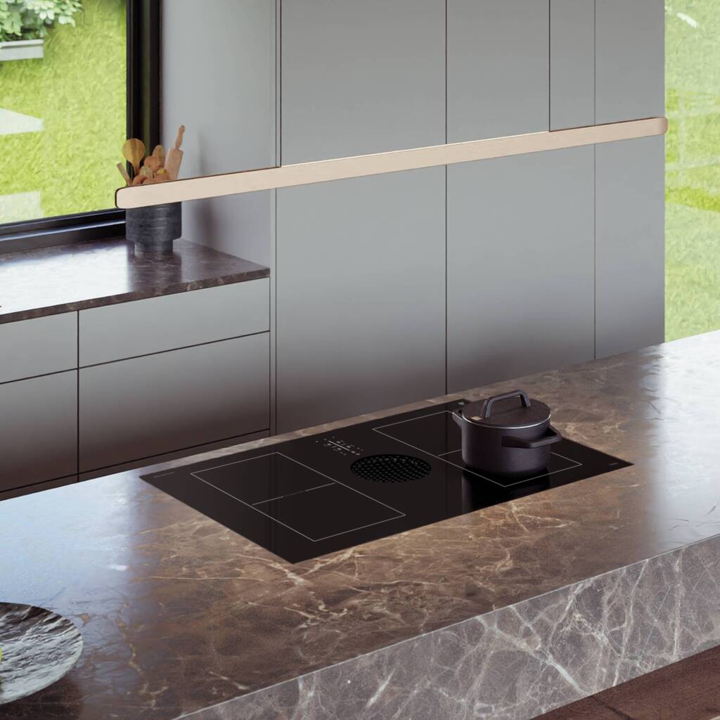 cooktop view with downdraft and pot on top of it