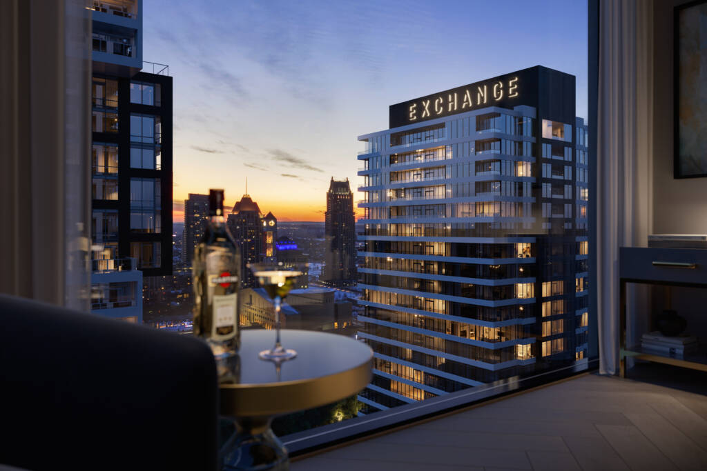 view of condo building at sunset with skyline in the back