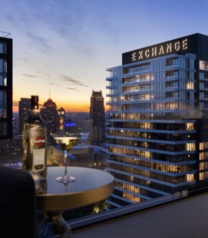 view of condo building at sunset with skyline in the back