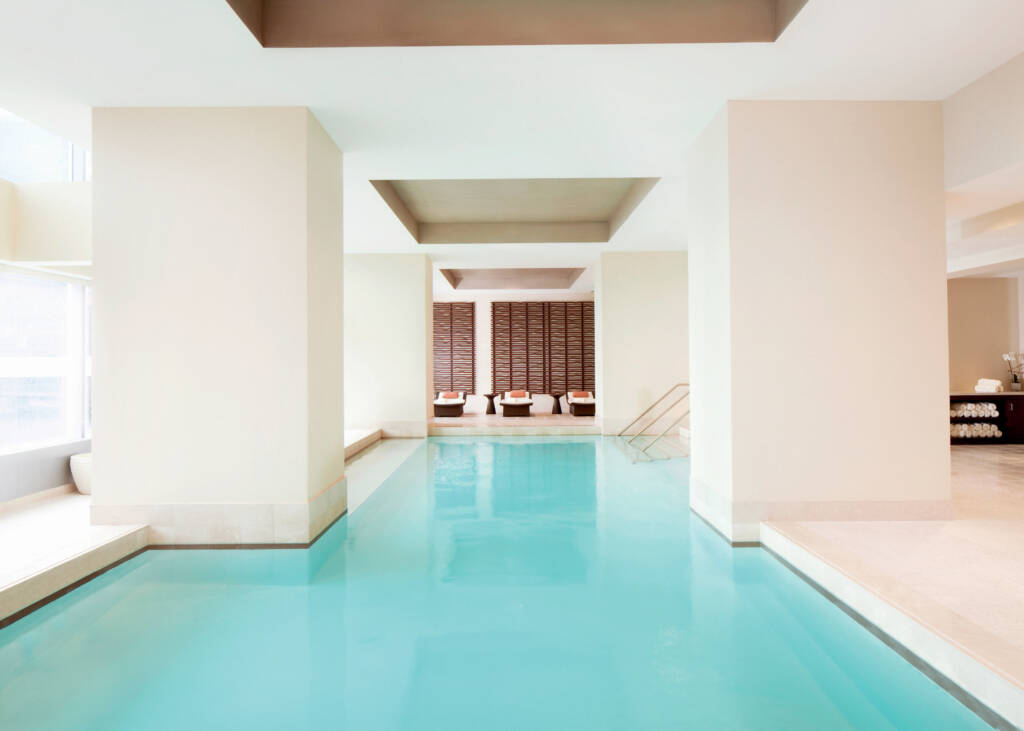 light blue inside pool in between white walls in a spa
