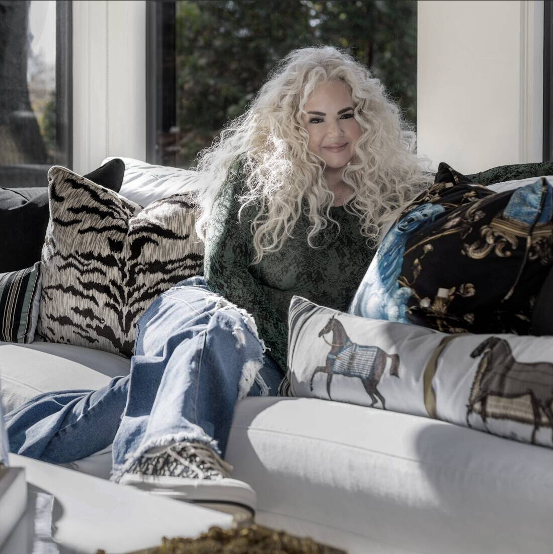 Lori Morris sitting on couch